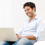 Man smiling as he checks he email