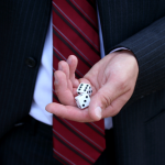 Man in suit rolling dice