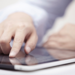 Person clicking an ad on a tablet