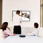 Three people participating in a video meeting over the Internet